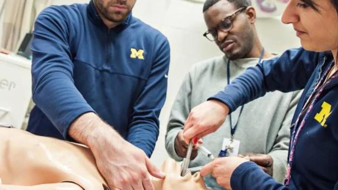 A group of people running a lab dummy simulation