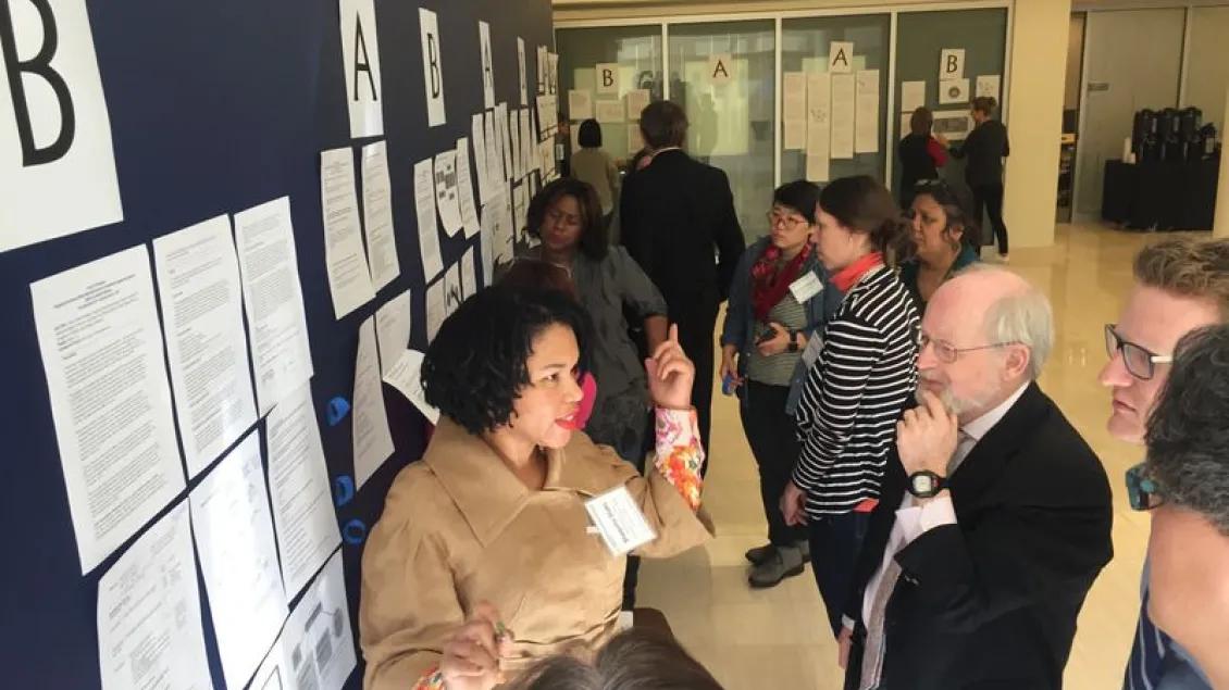 A group of people at a poster presentation