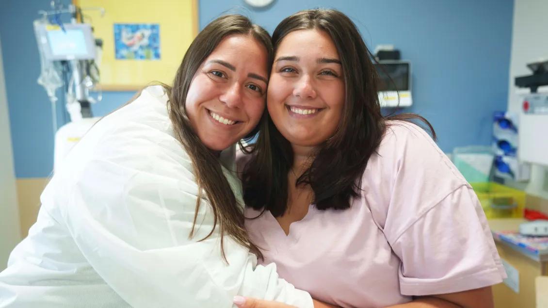 Nephrology Doctor hugs patient facing camera