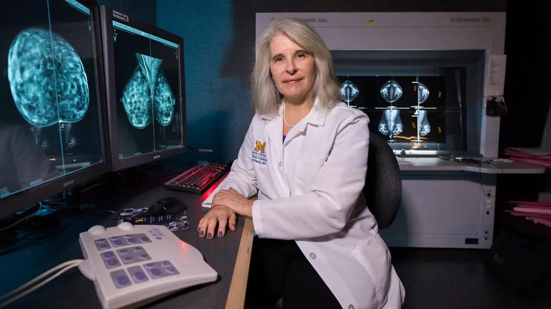Doctor sits Infront of MRI scans
