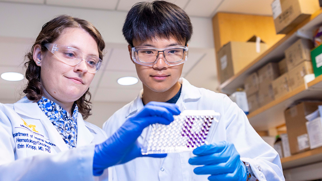 Dr. Kropp and lab member looking at speciman