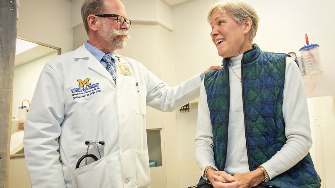Dr. Scott Schuetze meets with a female patient
