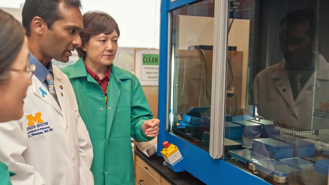 Dr. Arul Chinnaiyan with two female researchers