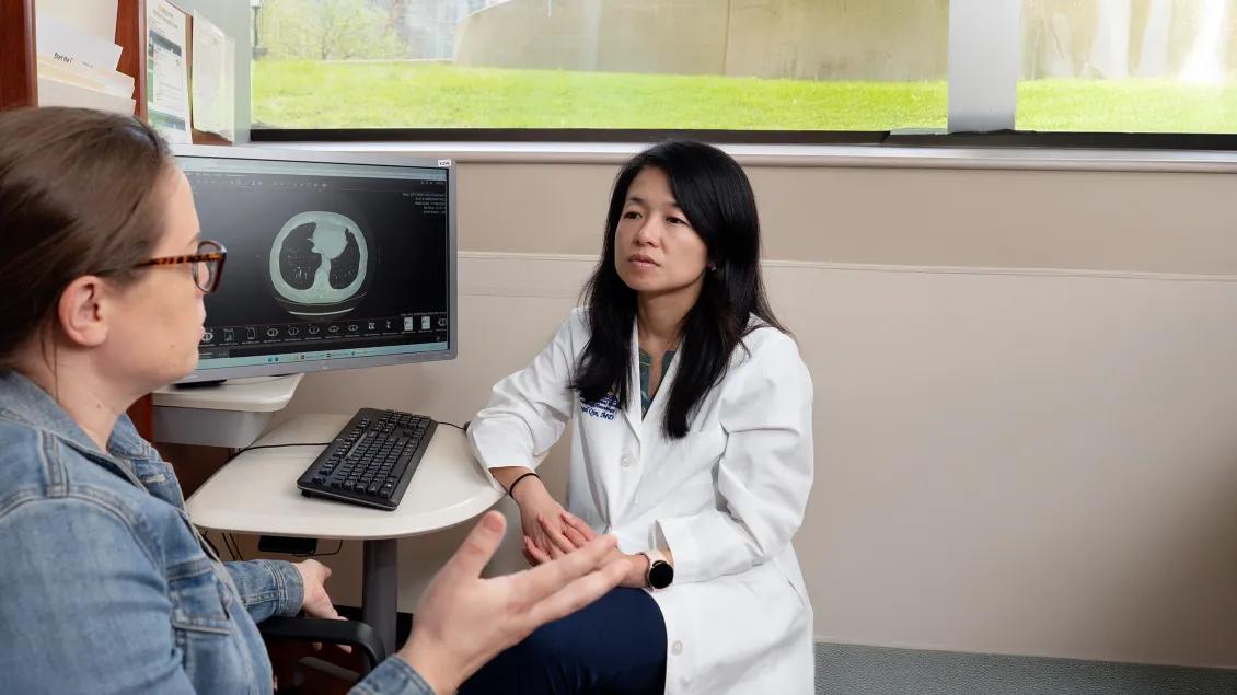 Dr Qin listening to patient