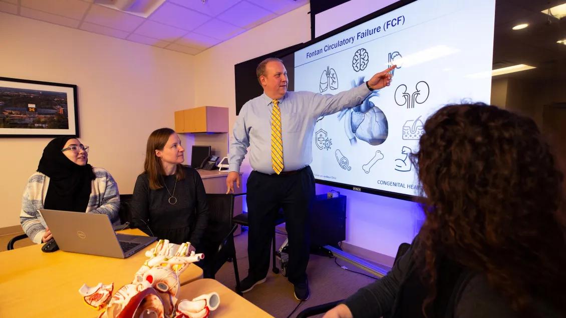 Pediatric cardiology team reviewing a presentation