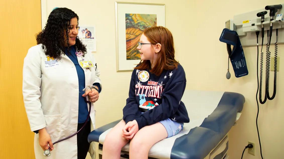 provider with a happy teenager at a clinic
