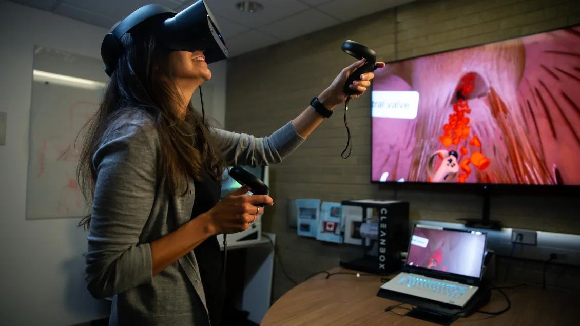 A person using a virtual reality tool with a television screen