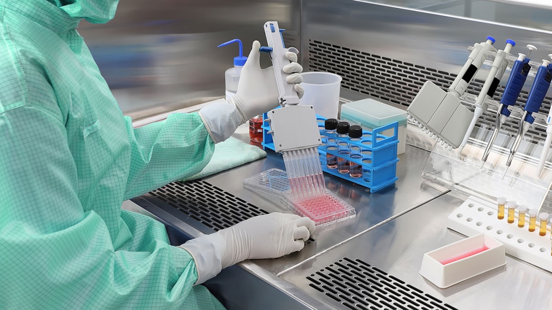 Laboratory technician uses a pipette