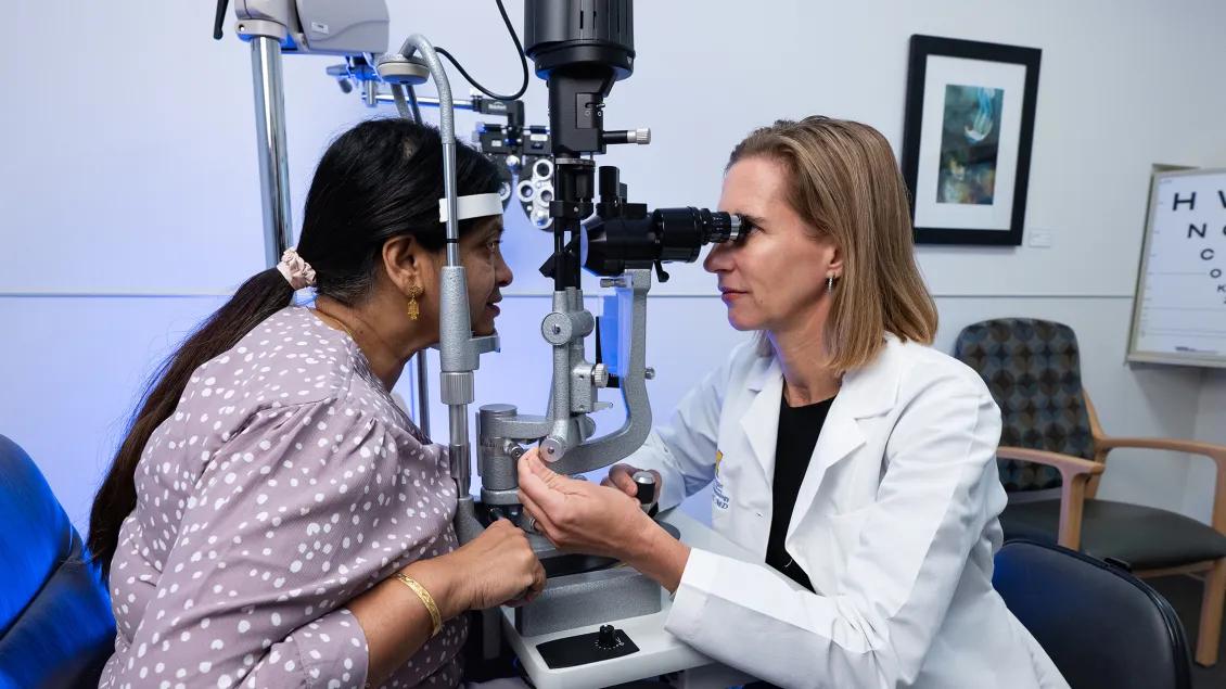 Dr. Maria Woodward evaluating a patient in an exam room