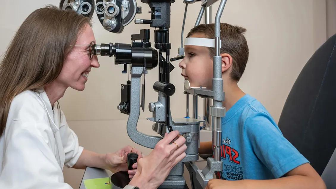Brianna Tracy, MD, examining a young patient in the pediatric ophthalmology clinic