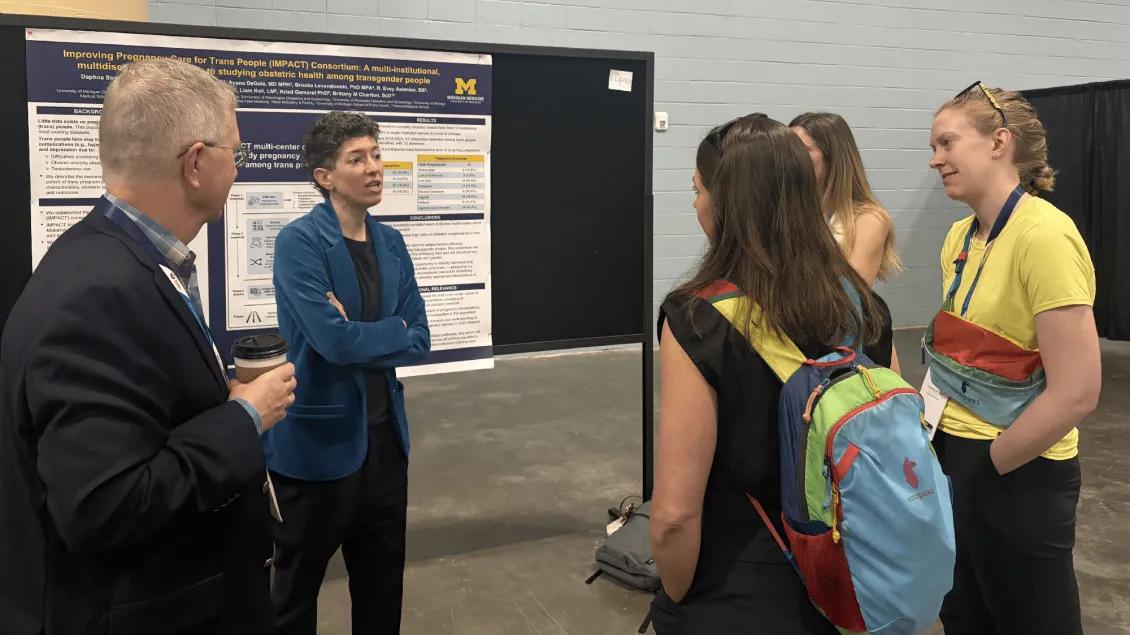 Team members discussing a research poster