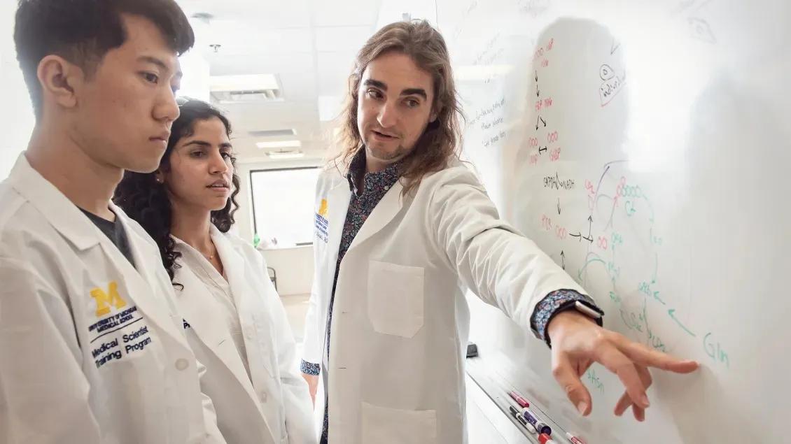 Team members looking at white board