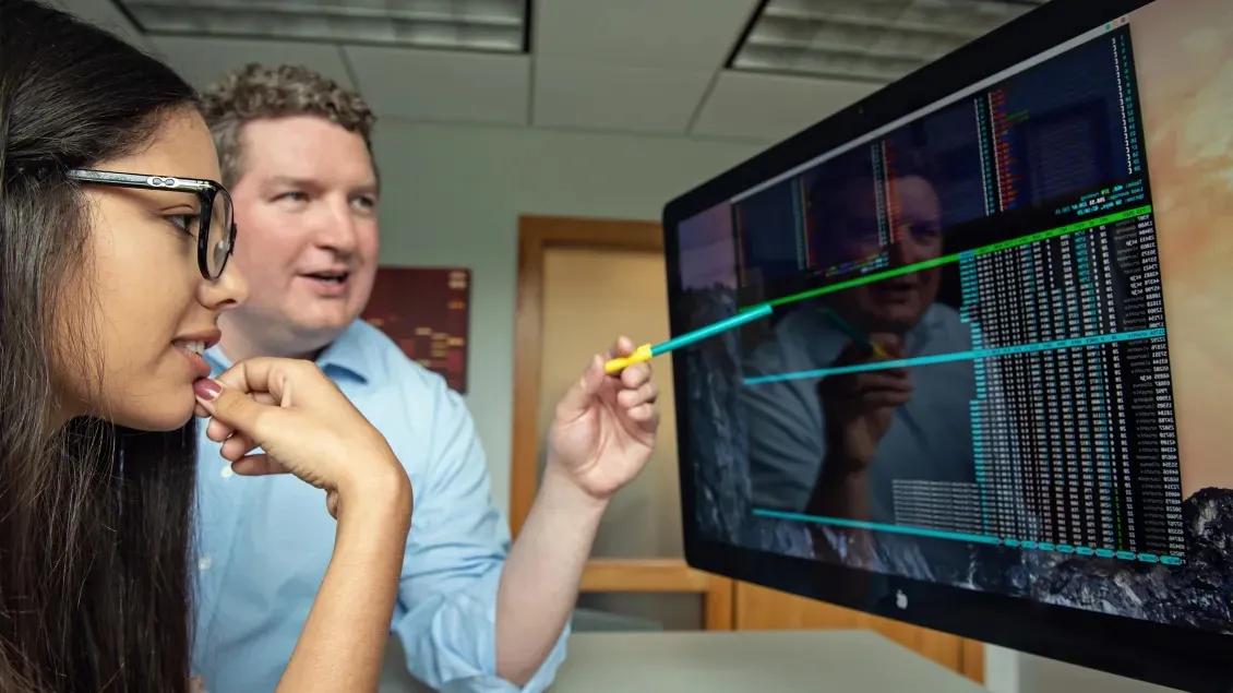 Team members looking at a computer