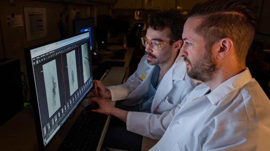 Doctor and resident looking at a radiographic image on a computer