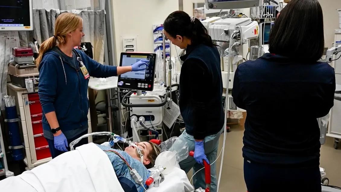 Critical Care team members taking patient vitals
