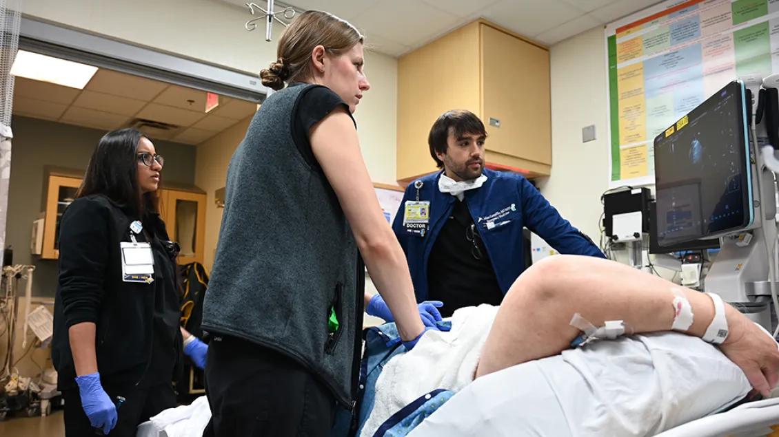 Emergency medicine team members assisting a patient
