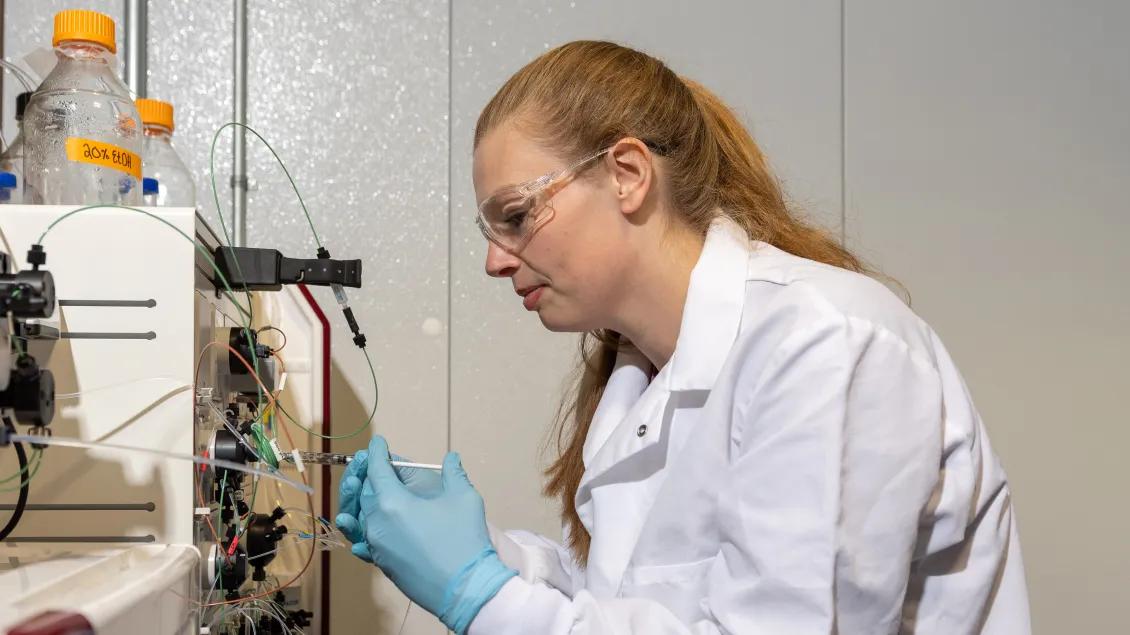 scientist injecting sample into HPLC