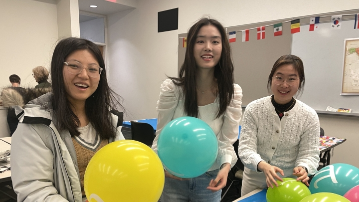  Girls celebrate diversity on Pi Day by decorating balloons.