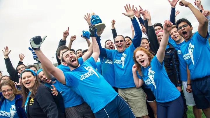 People raising their hands cheering