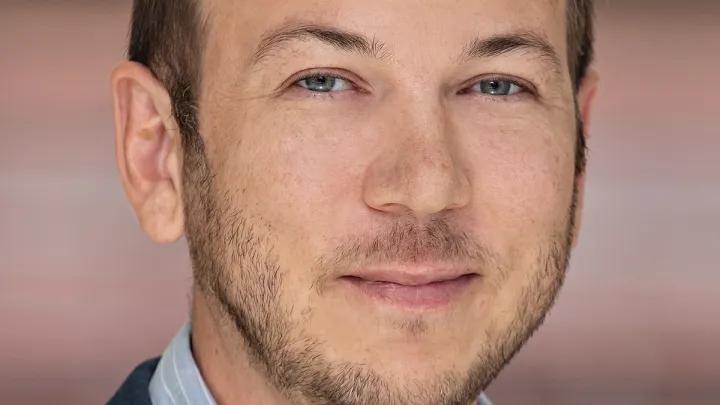 headshot of Adam Courtney