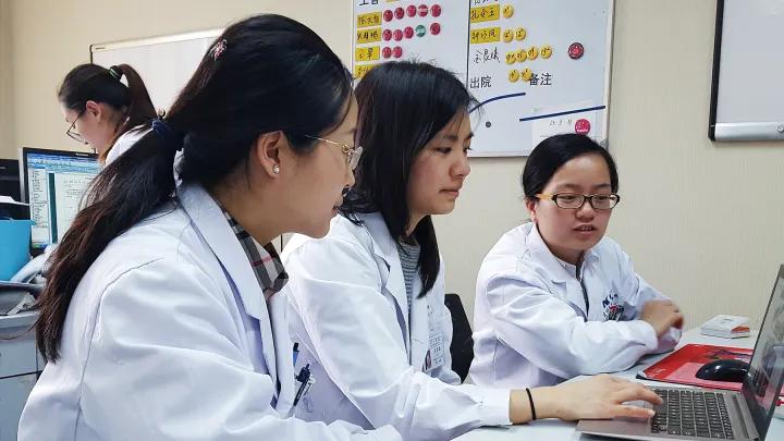 A group of research students working on a laptop