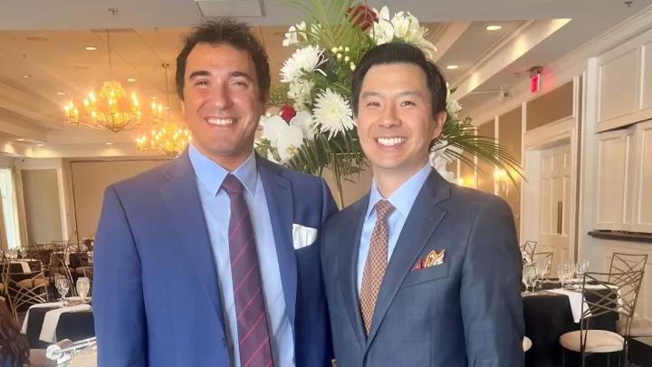 Two men smiling 