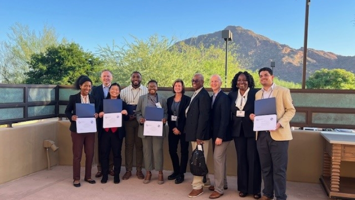 Participants & mentors stand outside with certificates, smiling, with a mountain backdrop—group photo from a PROSPECT event