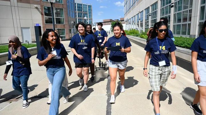 Students walking toward the camera on a campus tour