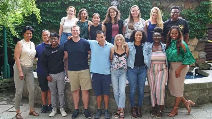 A group of people stand together to take a picture