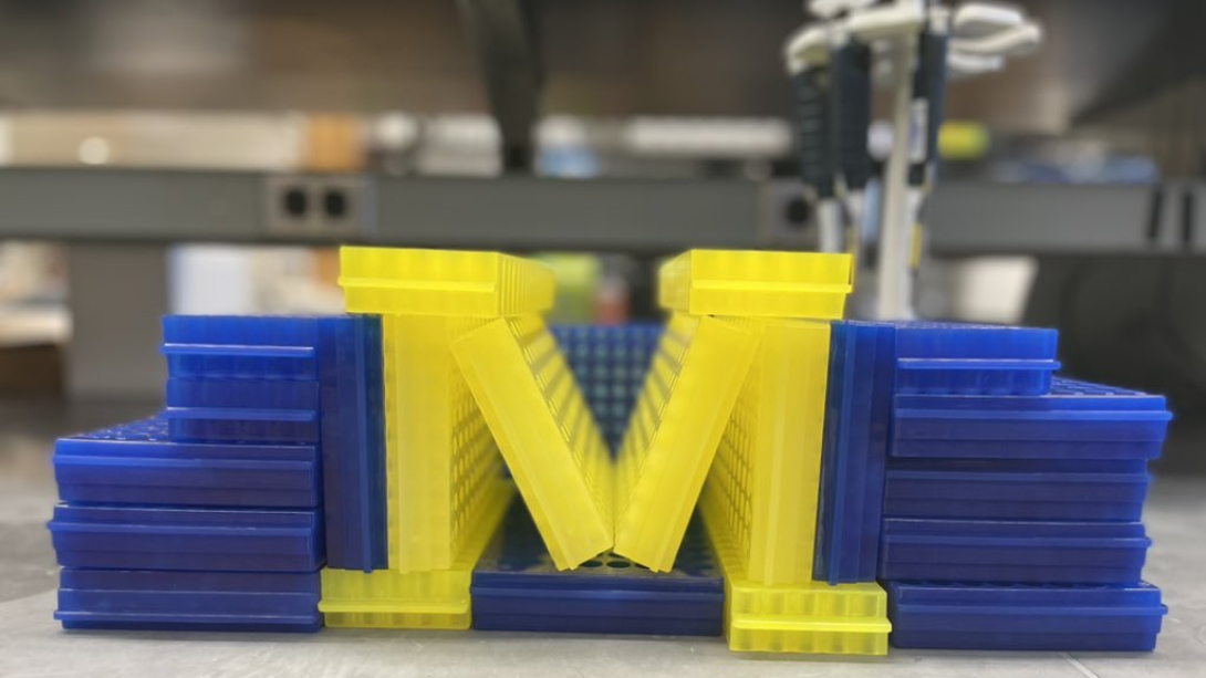 3D printed yellow block M surrounded in blue 