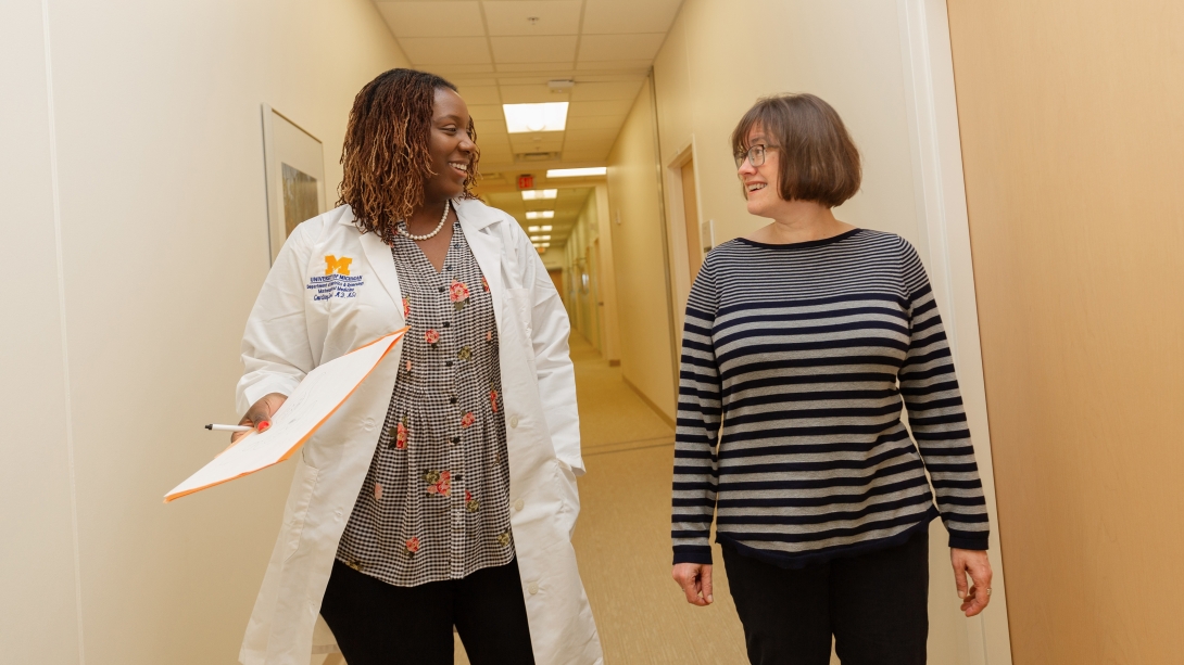 doctor walking alongside patient 