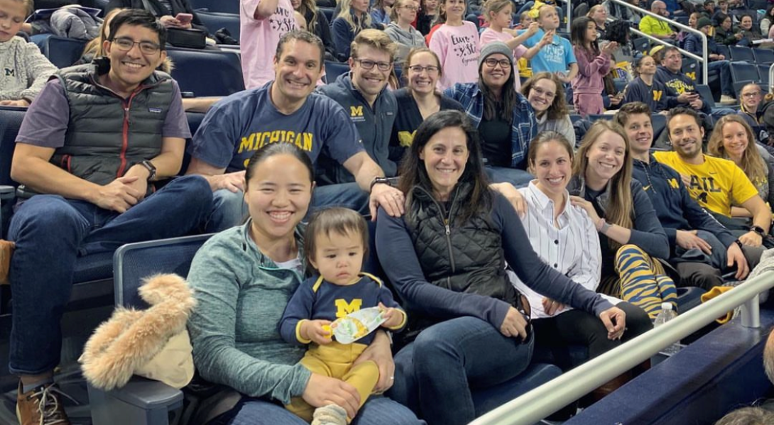 residents and fellows at a Michigan football game 