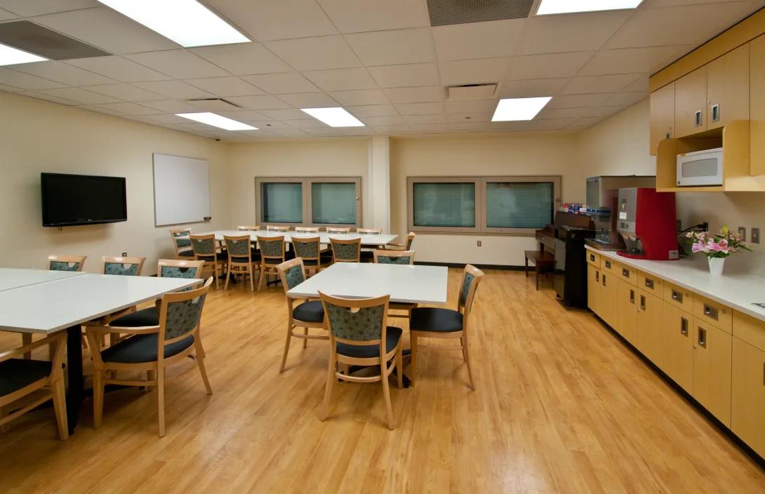 Break room with tables and coffee station for staff 