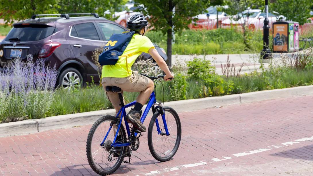 Person in yellow riding a bike downtown