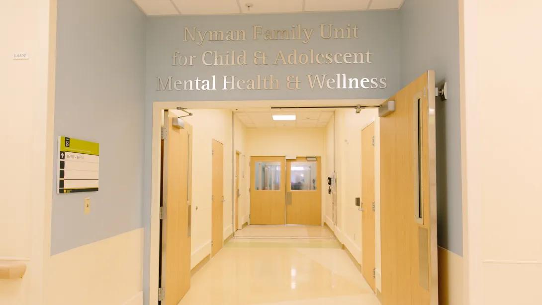 empty light filled hallway with inspirational quotes written on the wall
