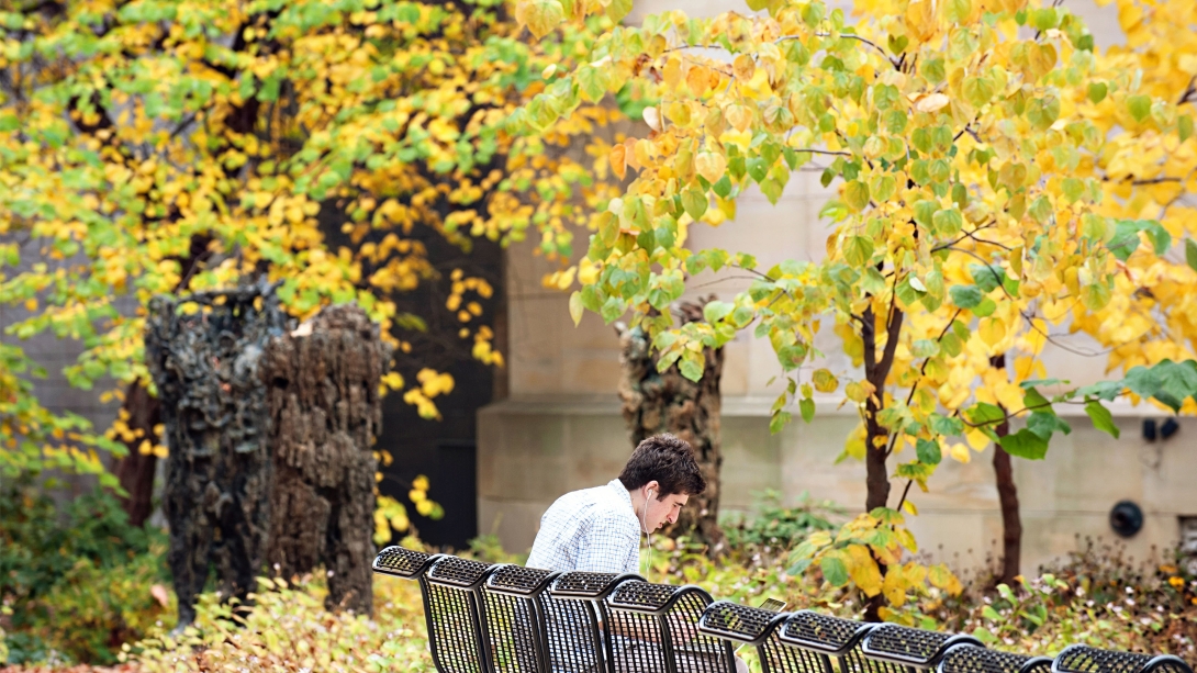 Man sitting on a bench in autumn
