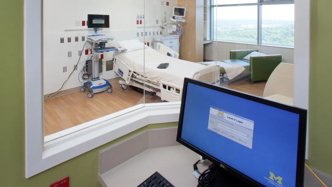 view of empty PICU room from monitoring station