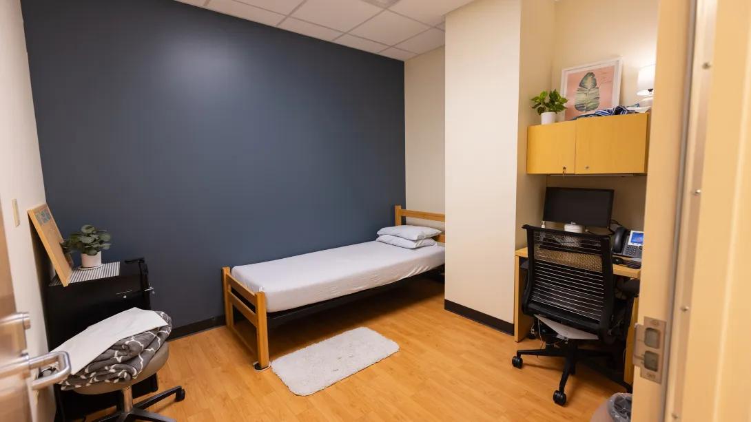 a room with a bed and a desk