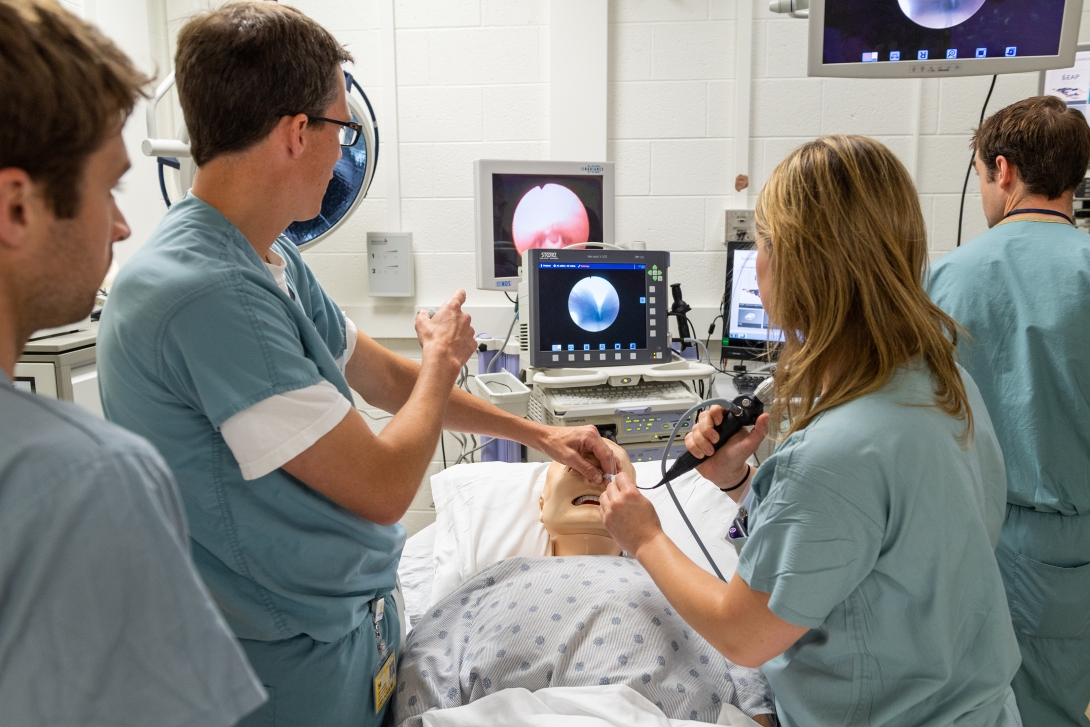 Otolaryngology students practice an exam in the simulation lab