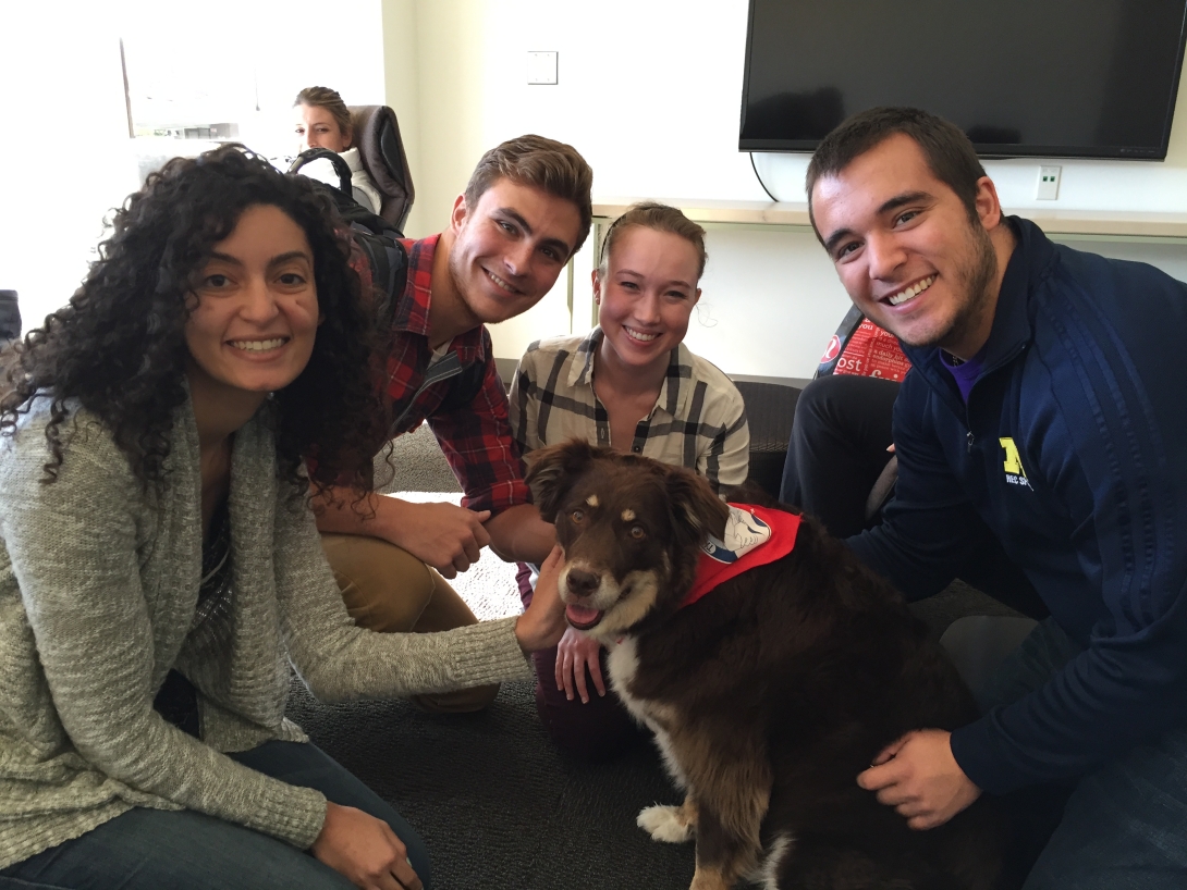 M Home Therapaws Students smiling with dog.