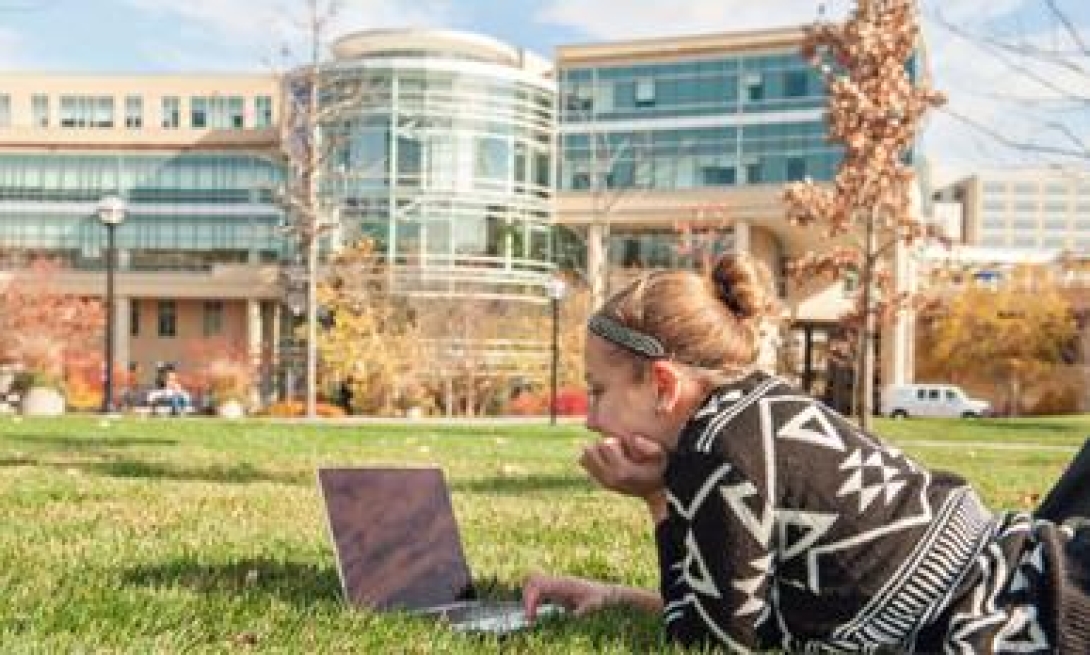 Girl working outside on her laptop