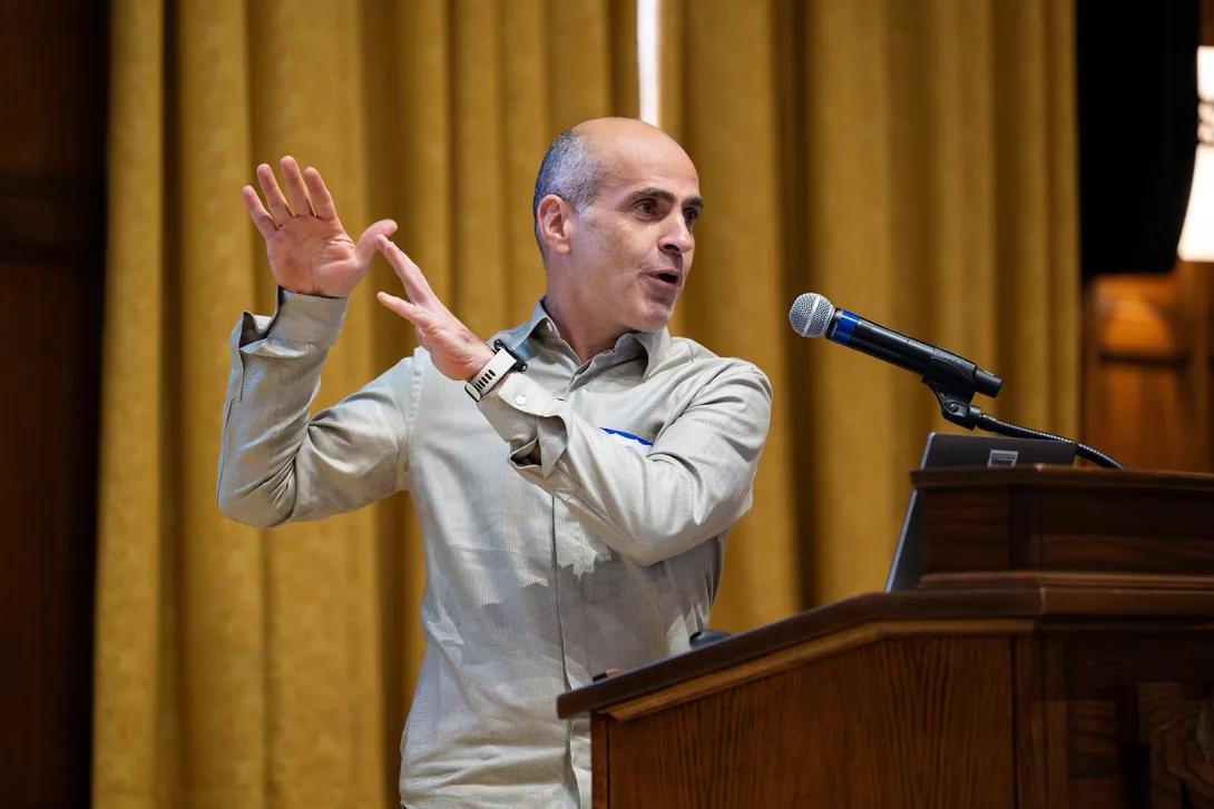 Diba gestures at the podium during his presentation