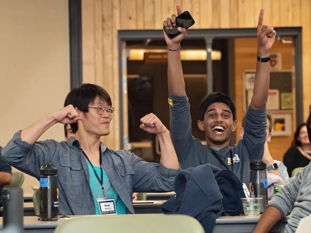 Two people at a seminar celebrating