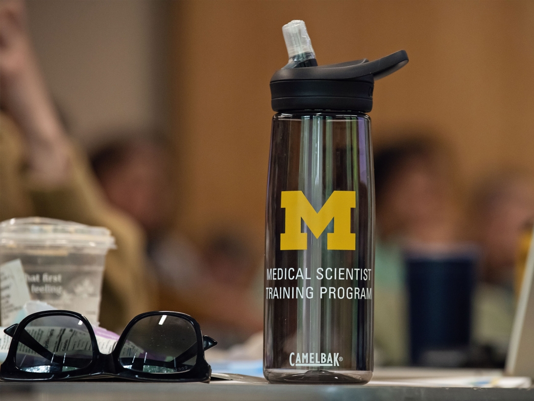 A water bottle with the Michigan block M