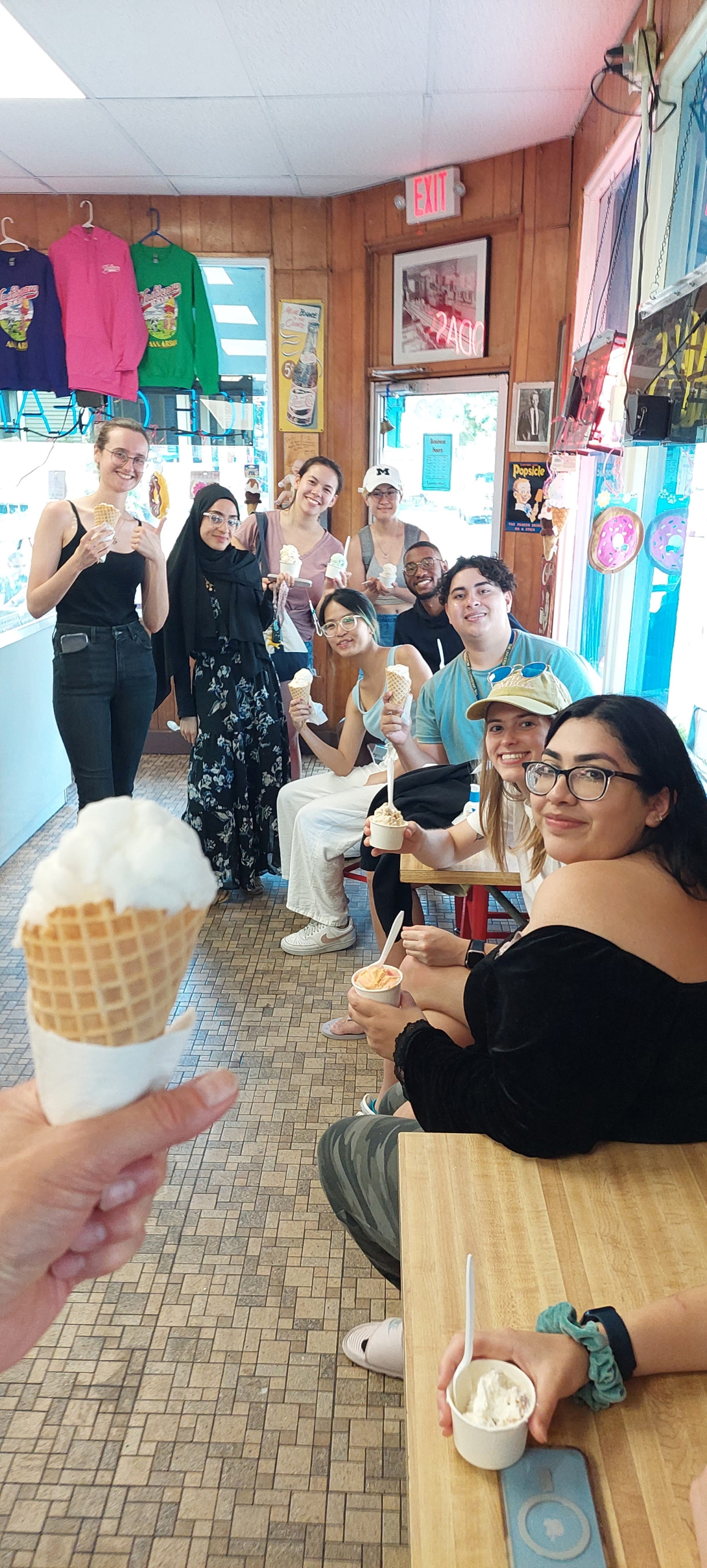 a group of people holding ice cream cones