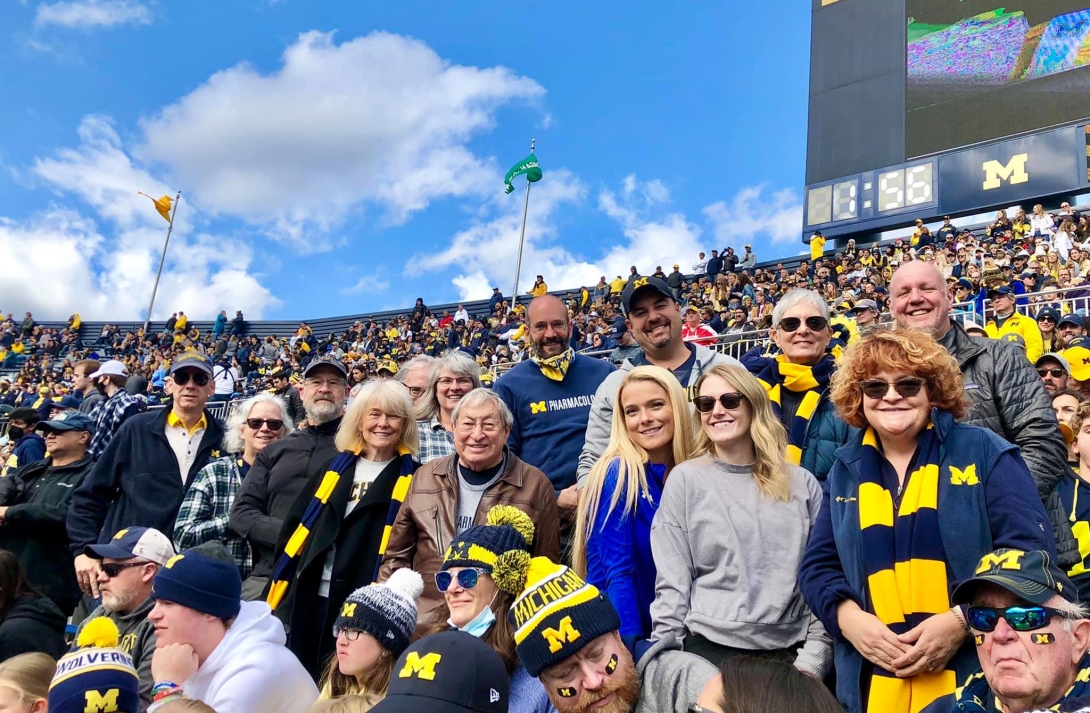 pharmacology staff smile at the stadium on game day
