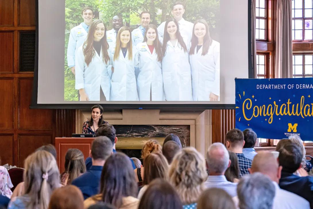 Dr. Helfrich speaks at podium at the 2024 Resident & Fellow Graduation