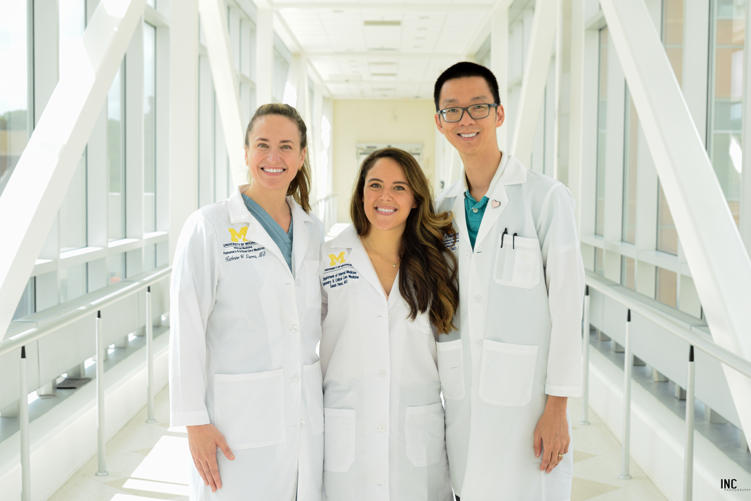 Three fellows standing in a hallway