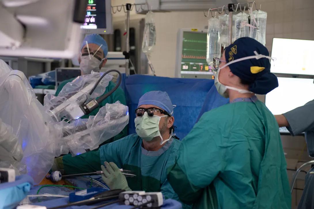A group of surgeons working with a medical robot