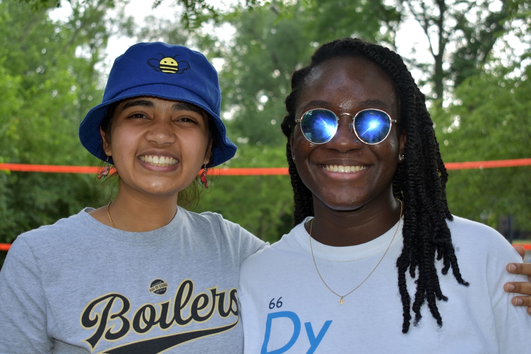 two girls smile together for camera